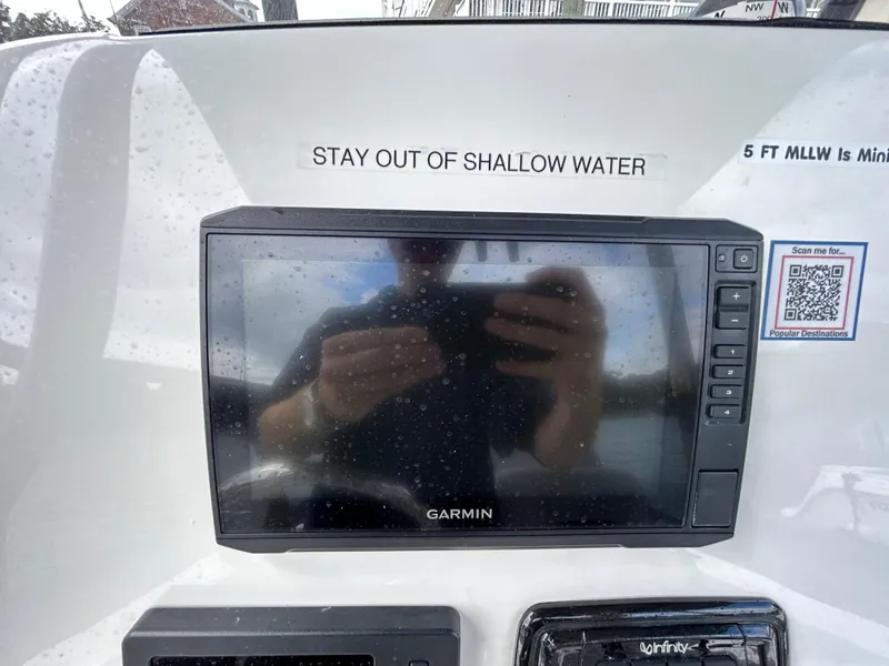 Slide: The Image of Garmin display on 2021 NauticStar 2302 Legacy boat dashboard with safety warning. - 9