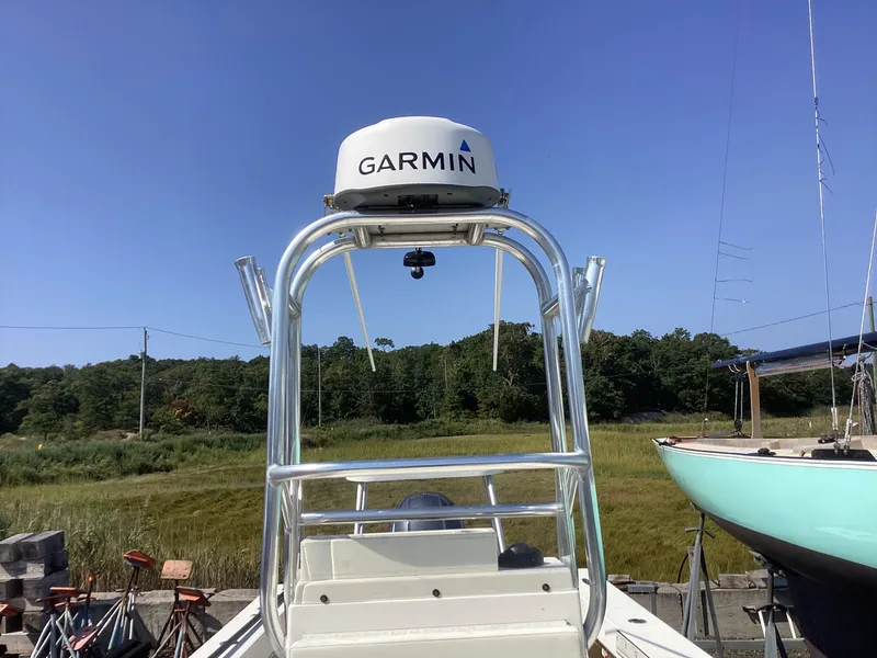 Slide: The Image of 2007 Jones Brothers 23 Cape Fisherman with Garmin radar, docked near grassy shoreline. - 11