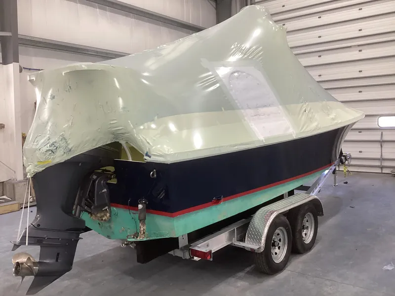 Slide: The Image of 2007 Jones Brothers 23 Cape Fisherman boat on trailer, partially covered, in a garage. - 17