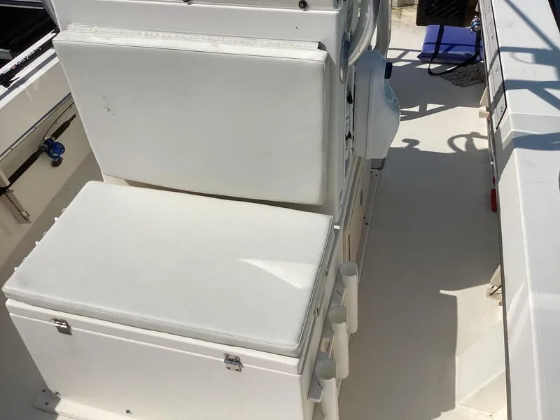Slide: The Image of 2007 Jones Brothers 23 Cape Fisherman boat interior with white seating and storage. - 4