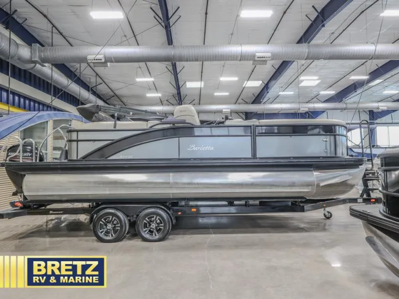 Slide: The Image of 2019 E-Class E22QC pontoon boat on trailer in showroom, Bretz RV & Marine. - 1
