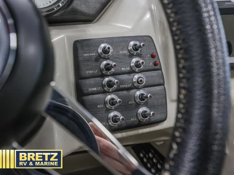 Slide: The Image of Control panel with switches in a 2019 E-Class E22QC boat, featuring various labeled functions. - 9