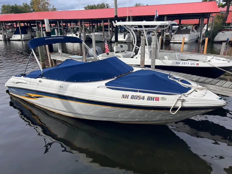 Slide: The Image of 2002 Chaparral 220 SSi boat docked with blue covers and canopy. - 1