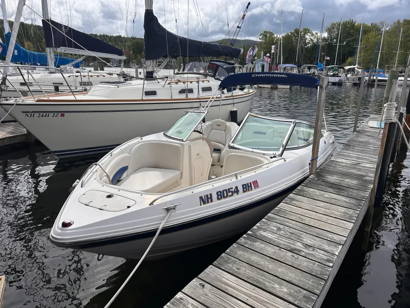Slide: The Image of 2002 Chaparral 220 SSi boat docked at marina with sailboats in background. - 2