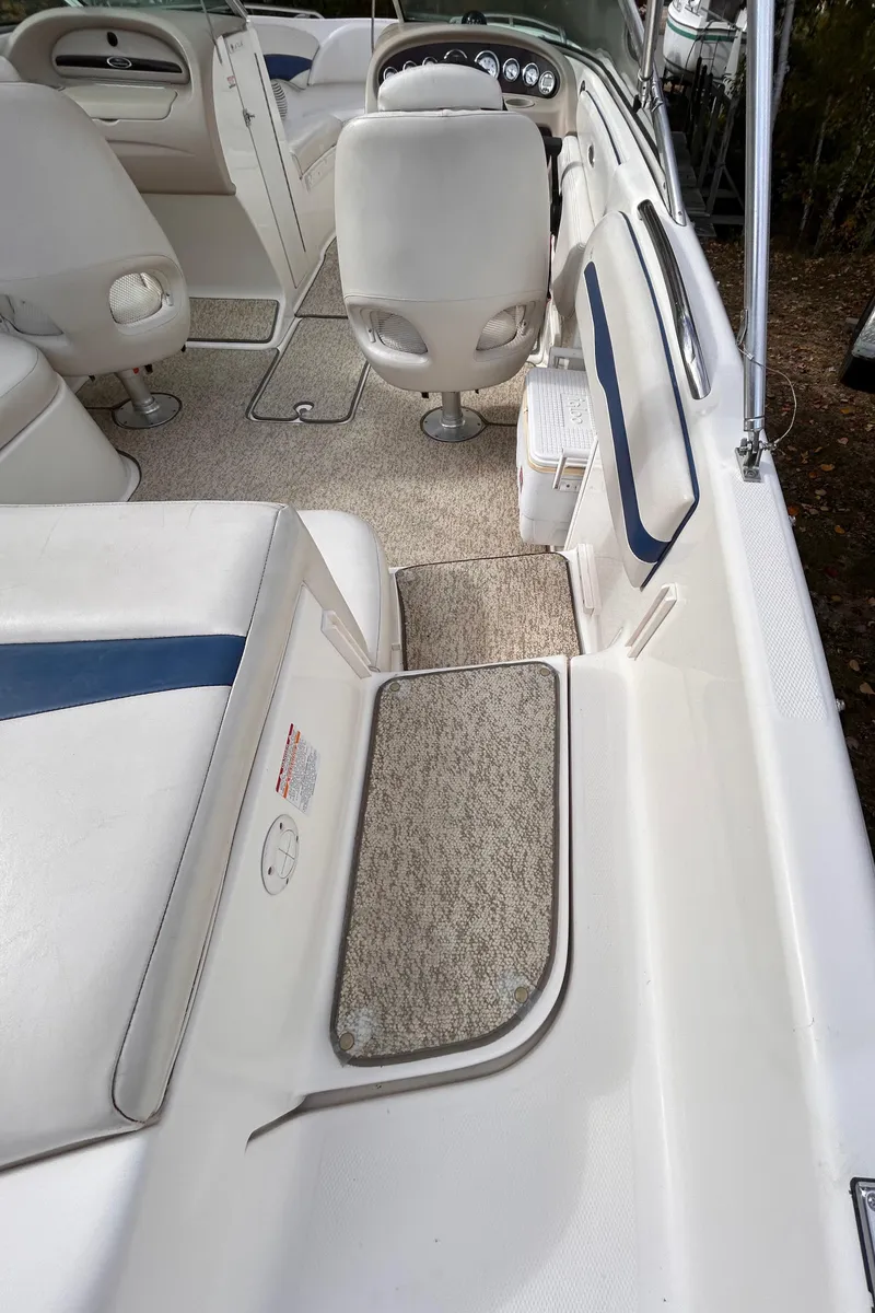 Slide: The Image of Interior of 2002 Chaparral 220 SSi boat with white seating and carpeted flooring. - 22