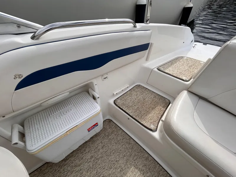 Slide: The Image of 2002 Chaparral 220 SSi boat interior with seating and cooler storage. - 24