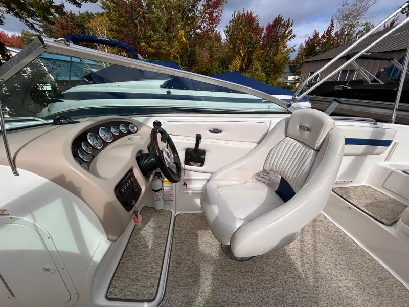 Slide: The Image of 2002 Chaparral 220 SSi boat interior with steering wheel and seating. - 32