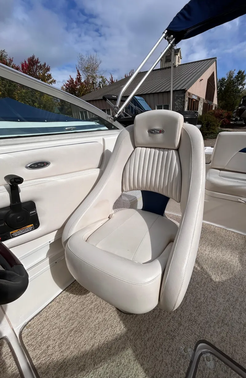 Slide: The Image of 2002 Chaparral 220 SSi boat interior with white leather seat and steering wheel. - 35