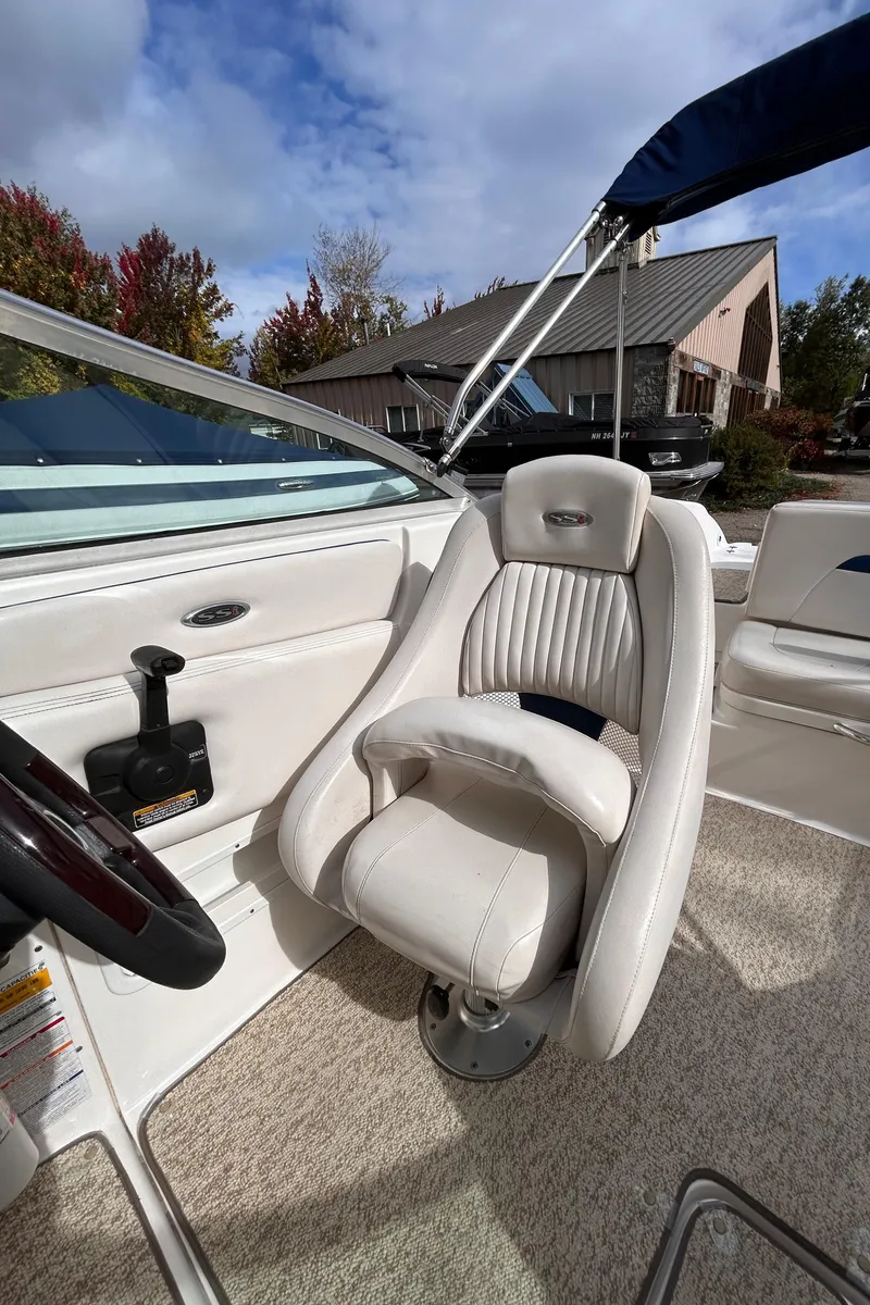 Slide: The Image of 2002 Chaparral 220 SSi boat interior with captain's chair and steering wheel. - 36