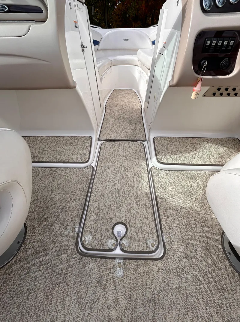 Slide: The Image of Interior view of 2002 Chaparral 220 SSi boat, featuring carpeted flooring and seating. - 37
