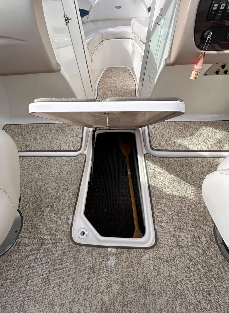 Slide: The Image of 2002 Chaparral 220 SSi boat interior with open storage compartment. - 38
