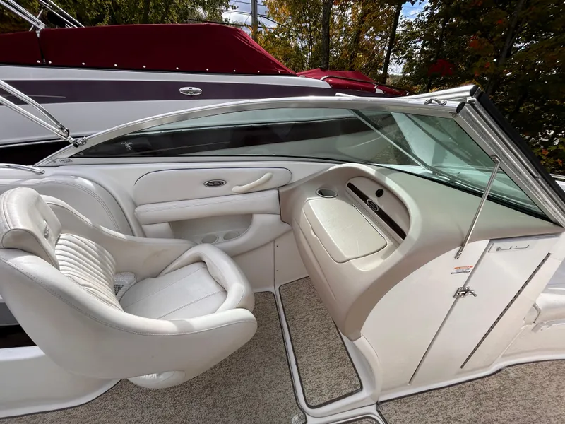 Slide: The Image of 2002 Chaparral 220 SSi boat interior with white seating and dashboard. - 39