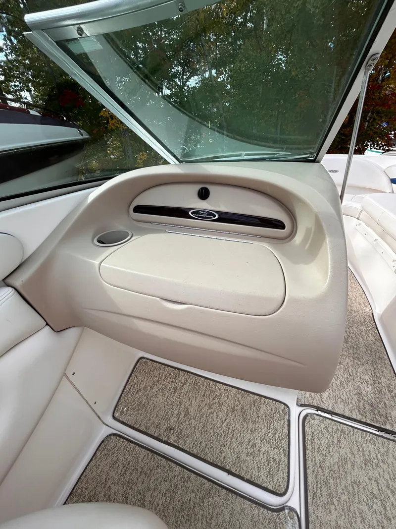Slide: The Image of Interior view of 2002 Chaparral 220 SSi boat, featuring beige upholstery and carpeted flooring. - 40