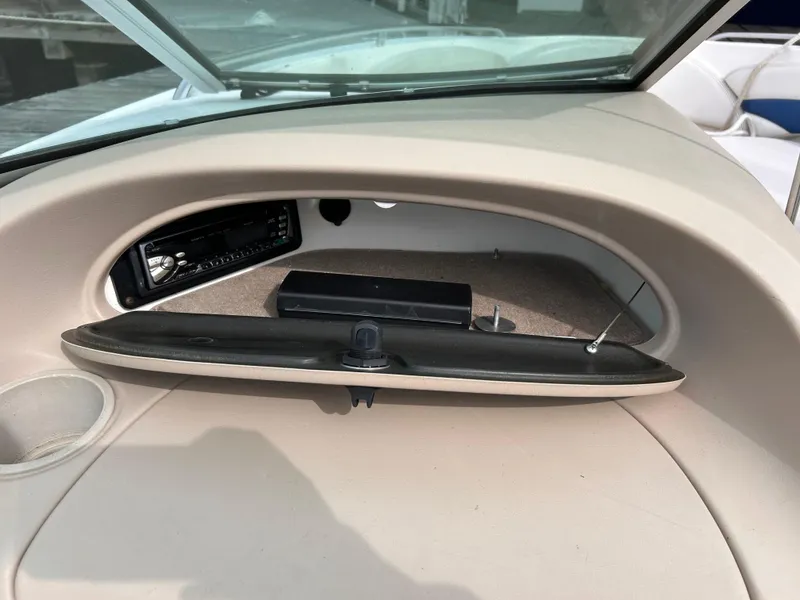 Slide: The Image of 2002 Chaparral 220 SSi boat dashboard with open glove compartment and stereo system. - 41