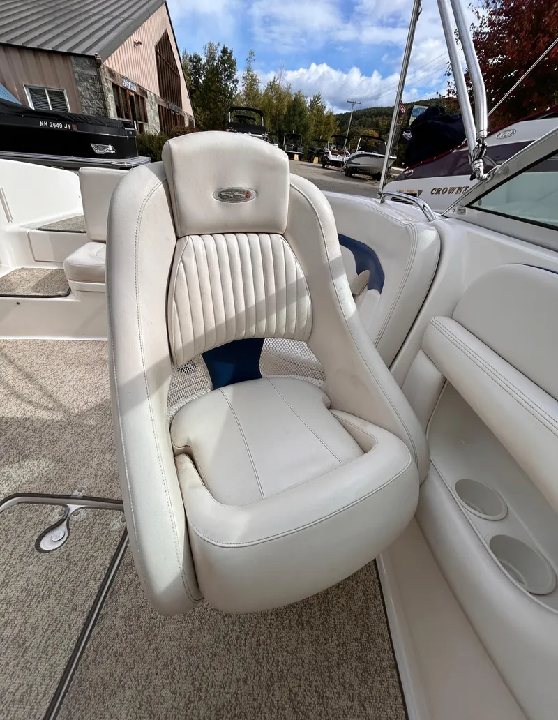 Slide: The Image of 2002 Chaparral 220 SSi boat interior with white leather seat and cup holders. - 43