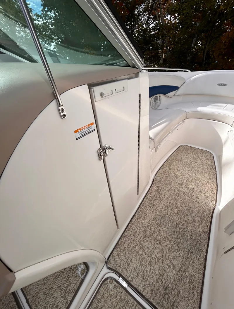 Slide: The Image of 2002 Chaparral 220 SSi boat interior with white seating and carpeted flooring. - 46