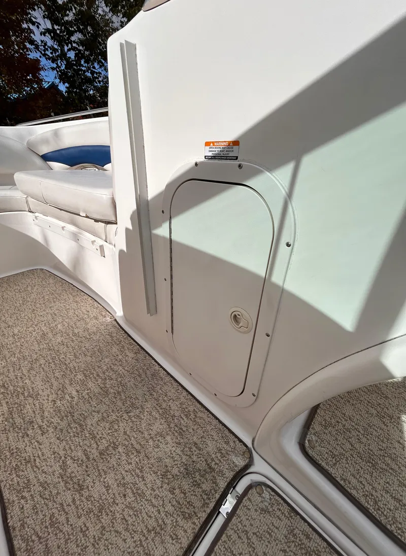 Slide: The Image of 2002 Chaparral 220 SSi boat interior with carpeted flooring and storage compartment. - 49