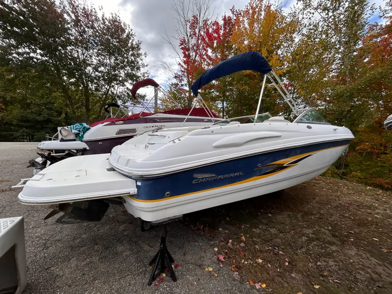 Slide: The Image of 2002 Chaparral 220 SSi boat on display with autumn foliage background. - 6