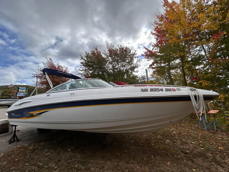 Slide: The Image of 2002 Chaparral 220 SSi boat on land, surrounded by autumn trees. - 7