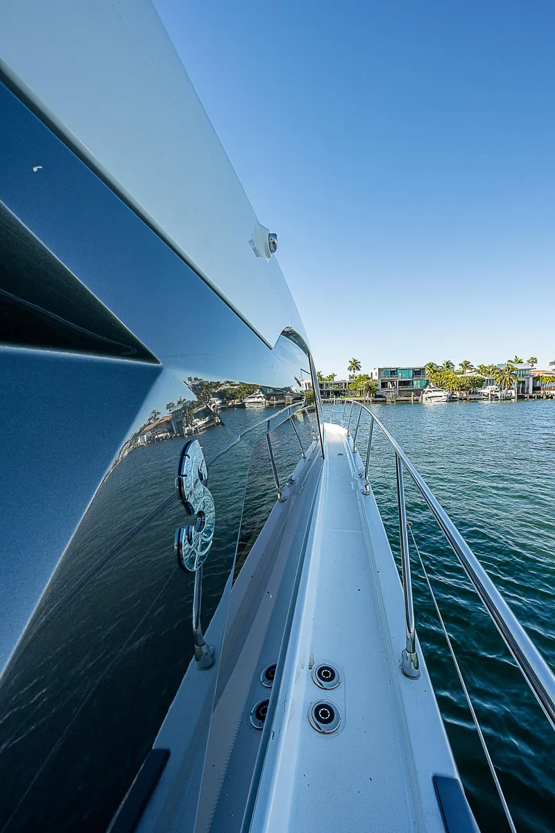 Slide: The Image of 2022 Beneteau Gran Turismo 45 yacht on serene water, side view. - 21