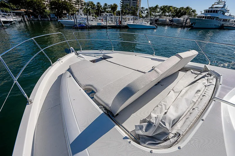 Slide: The Image of Beneteau Gran Turismo 45 yacht bow with sunbed, docked in a marina, 2022 model. - 27