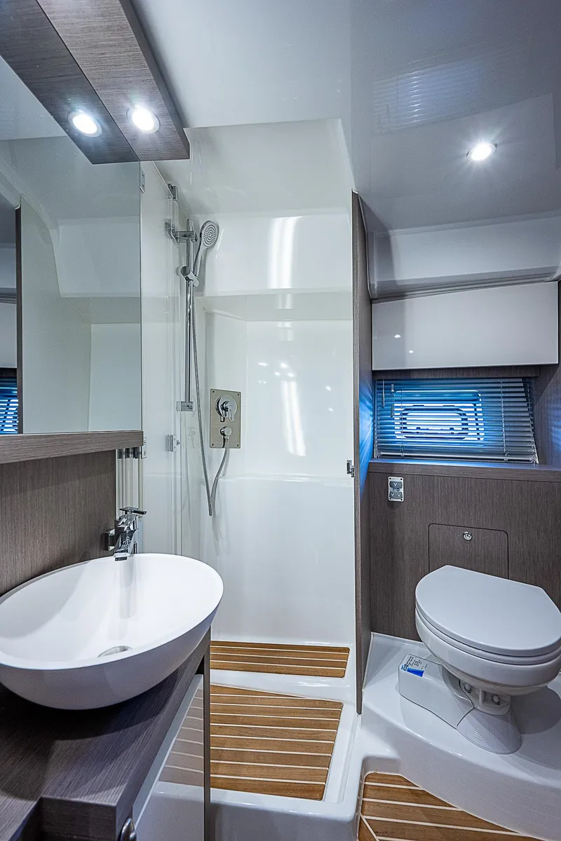 Slide: The Image of Modern bathroom in 2022 Beneteau Gran Turismo 45 yacht with sleek fixtures and wood accents. - 33