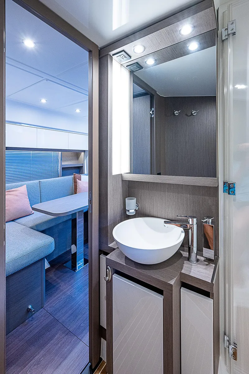 Slide: The Image of 2022 Beneteau Gran Turismo 45 yacht interior with modern bathroom and seating area. - 34