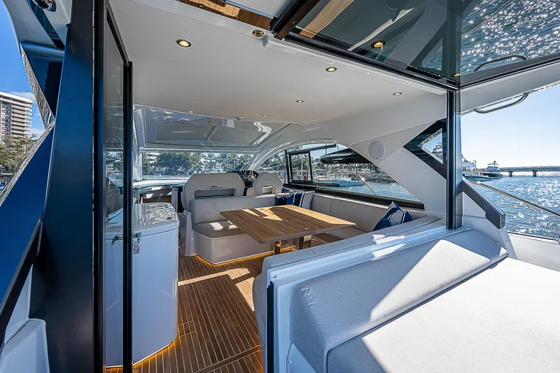 Slide: The Image of Luxurious interior of 2022 Beneteau Gran Turismo 45 yacht with elegant seating and dining area. - 38