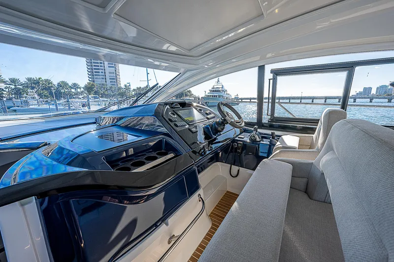 Slide: The Image of Interior of 2022 Beneteau Gran Turismo 45 yacht, featuring modern helm and seating. - 39