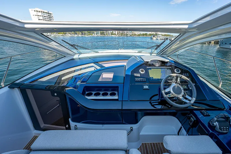 Slide: The Image of 2022 Beneteau Gran Turismo 45 helm with modern controls and panoramic water view. - 41