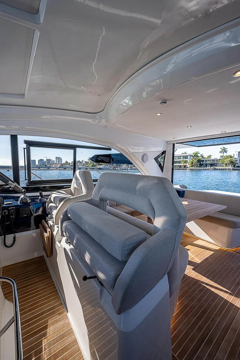 Slide: The Image of Interior of 2022 Beneteau Gran Turismo 45 yacht with modern seating and panoramic windows. - 43