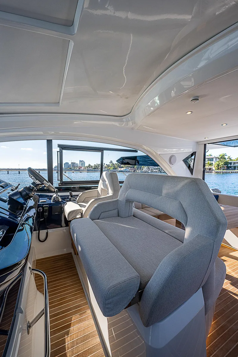 Slide: The Image of Interior of 2022 Beneteau Gran Turismo 45 yacht with plush seating and panoramic windows. - 44