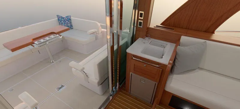 Slide: The Image of Interior of 2025 Sabre 51 Salon Express yacht, featuring seating and kitchenette. - 20