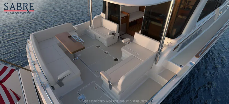 Slide: The Image of 2025 Sabre 51 Salon Express yacht with spacious deck seating on calm water. - 6