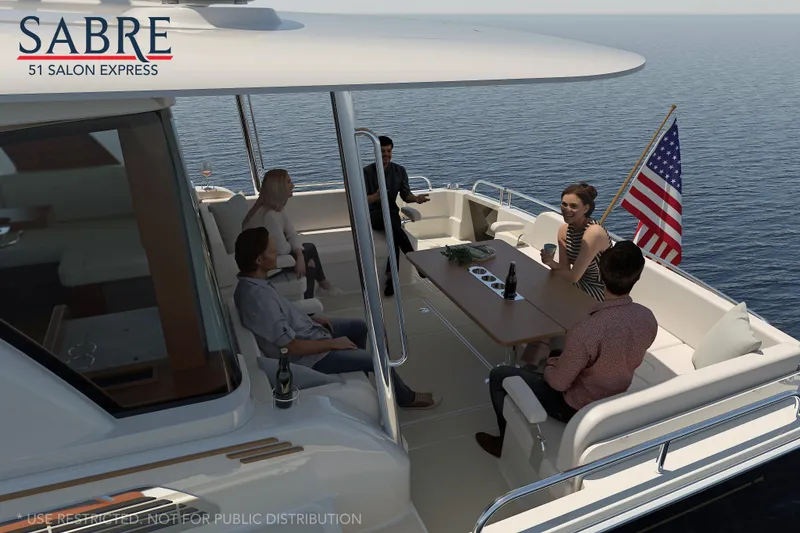 Slide: The Image of People relaxing on the deck of a 2025 Sabre 51 Salon Express yacht. - 8