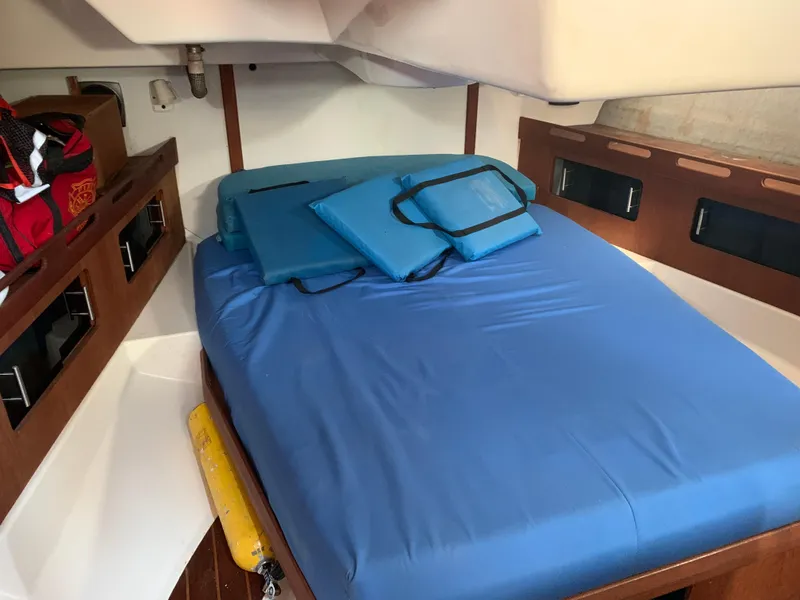 Slide: The Image of Cozy cabin interior of 1985 Hunter Legend 40 sailboat with blue bedding. - 11