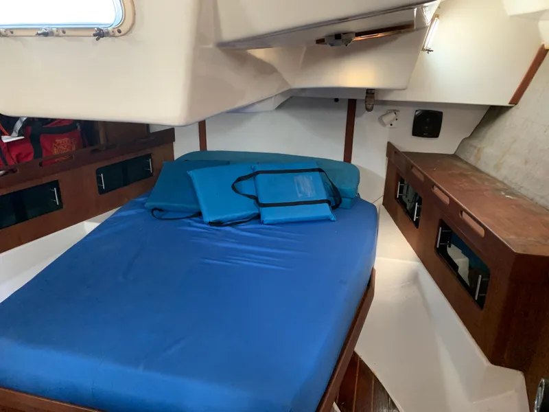 Slide: The Image of Interior cabin of 1985 Hunter Legend 40 sailboat with blue bedding. - 13