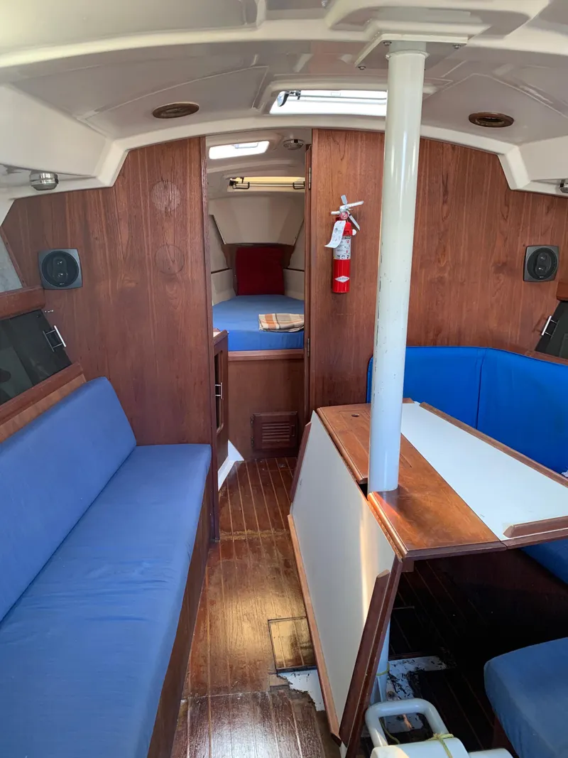 Slide: The Image of Interior of 1985 Hunter Legend 40 sailboat with blue seating and wood paneling. - 17