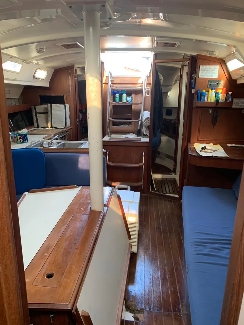 Slide: The Image of Interior of 1985 Hunter Legend 40 sailboat with wood finish and blue seating. - 19