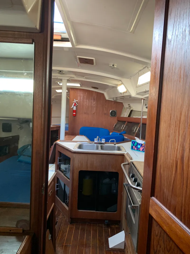 Slide: The Image of 1985 Hunter Legend 40 yacht interior with wooden cabinetry and kitchen area. - 20