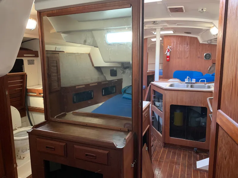 Slide: The Image of Interior of 1985 Hunter Legend 40 sailboat with wooden cabinetry and compact kitchen area. - 21