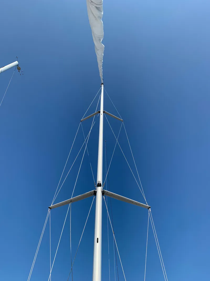 Slide: The Image of Tall mast of 1985 Hunter Legend 40 sailboat against clear blue sky. - 23