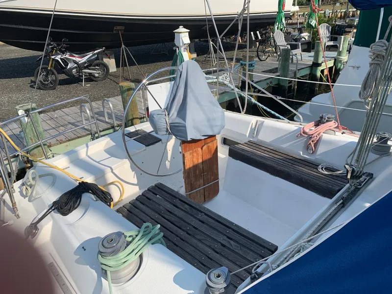 Slide: The Image of 1985 Hunter Legend 40 sailboat cockpit with covered wheel, docked at marina. - 24