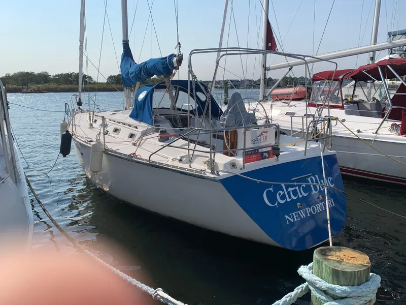 Slide: The Image of 1985 Hunter Legend 40 sailboat docked, named "Celtic Blue," in a marina setting. - 27