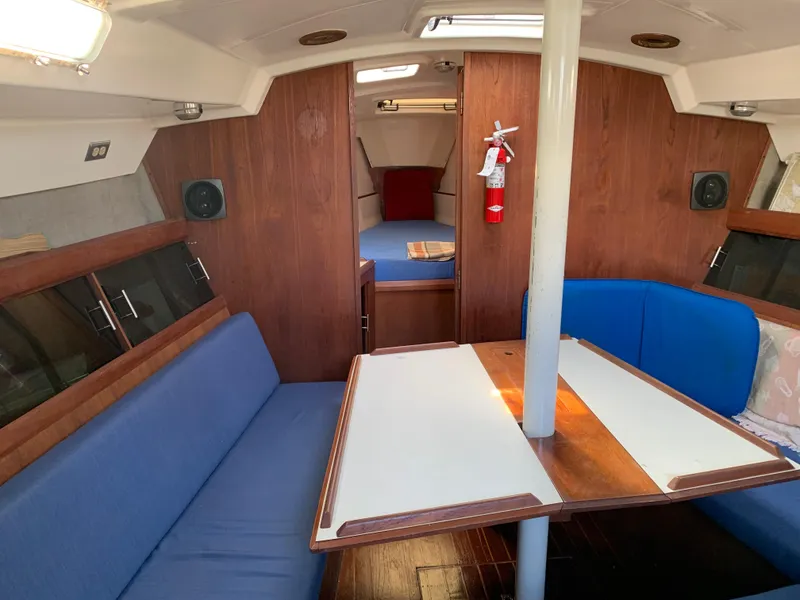Slide: The Image of Interior of 1985 Hunter Legend 40 sailboat with blue seating and wooden accents. - 3