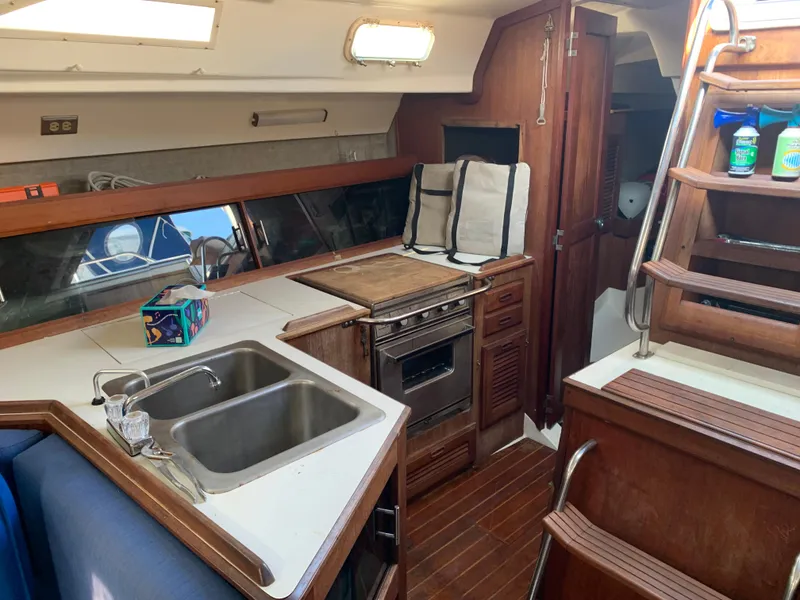 Slide: The Image of Interior of 1985 Hunter Legend 40 sailboat with kitchen and wooden cabinetry. - 4