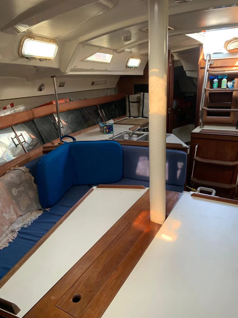 Slide: The Image of Interior of 1985 Hunter Legend 40 sailboat with blue seating and wooden accents. - 6