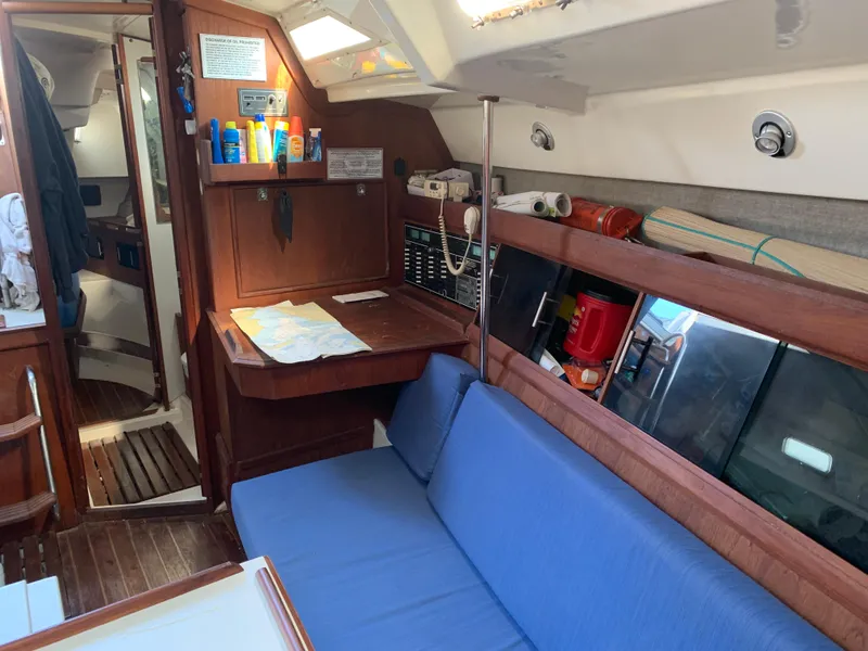 Slide: The Image of Interior of 1985 Hunter Legend 40 sailboat with blue seating and wooden cabinetry. - 7