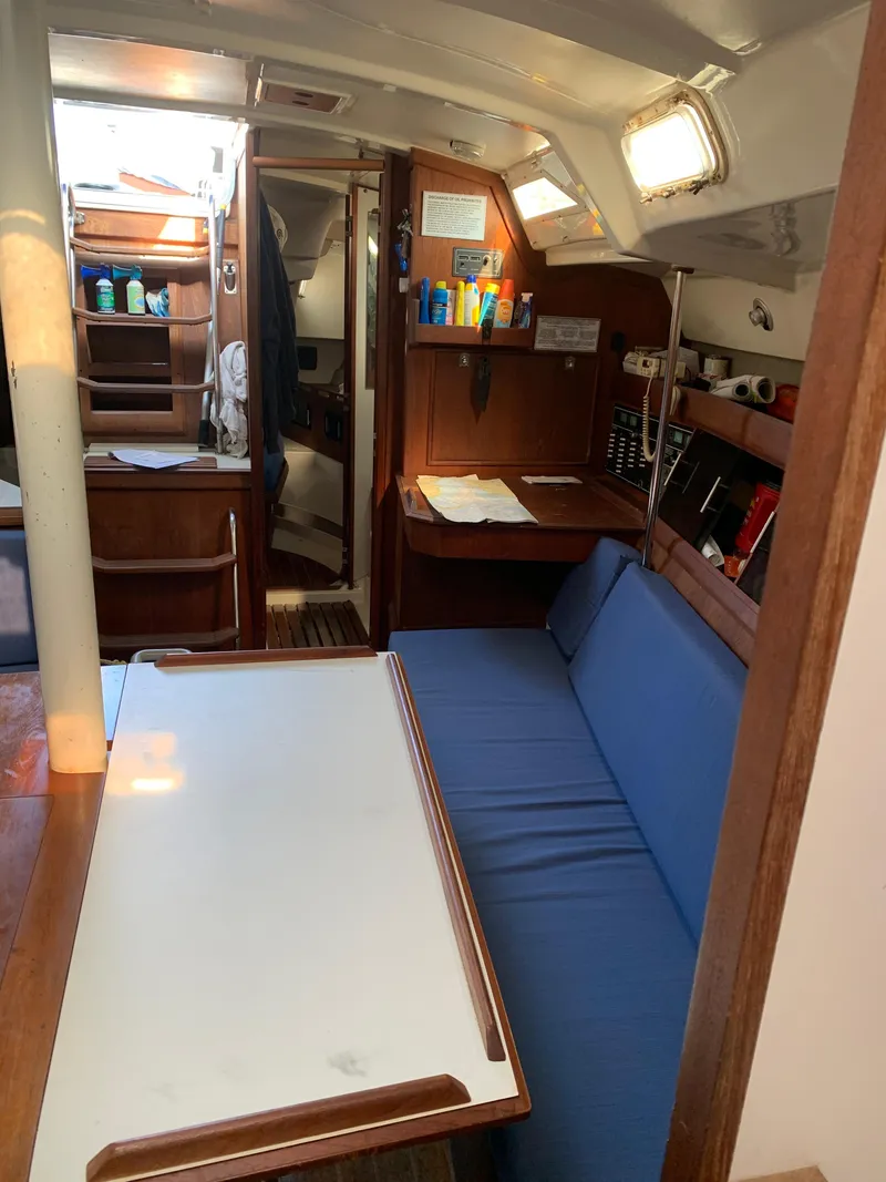 Slide: The Image of Interior of 1985 Hunter Legend 40 sailboat with blue seating and wooden cabinetry. - 8