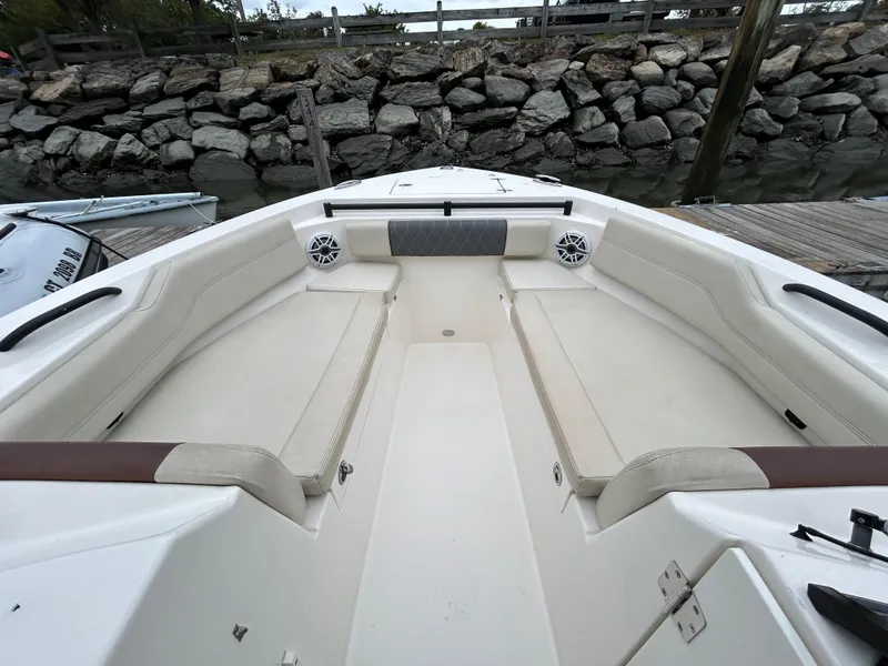 Slide: The Image of 2022 Cobia 240 Dual Console boat interior with spacious seating and speakers. - 10